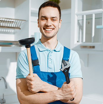 Rick Lucas Plumbing staff holding a water pump